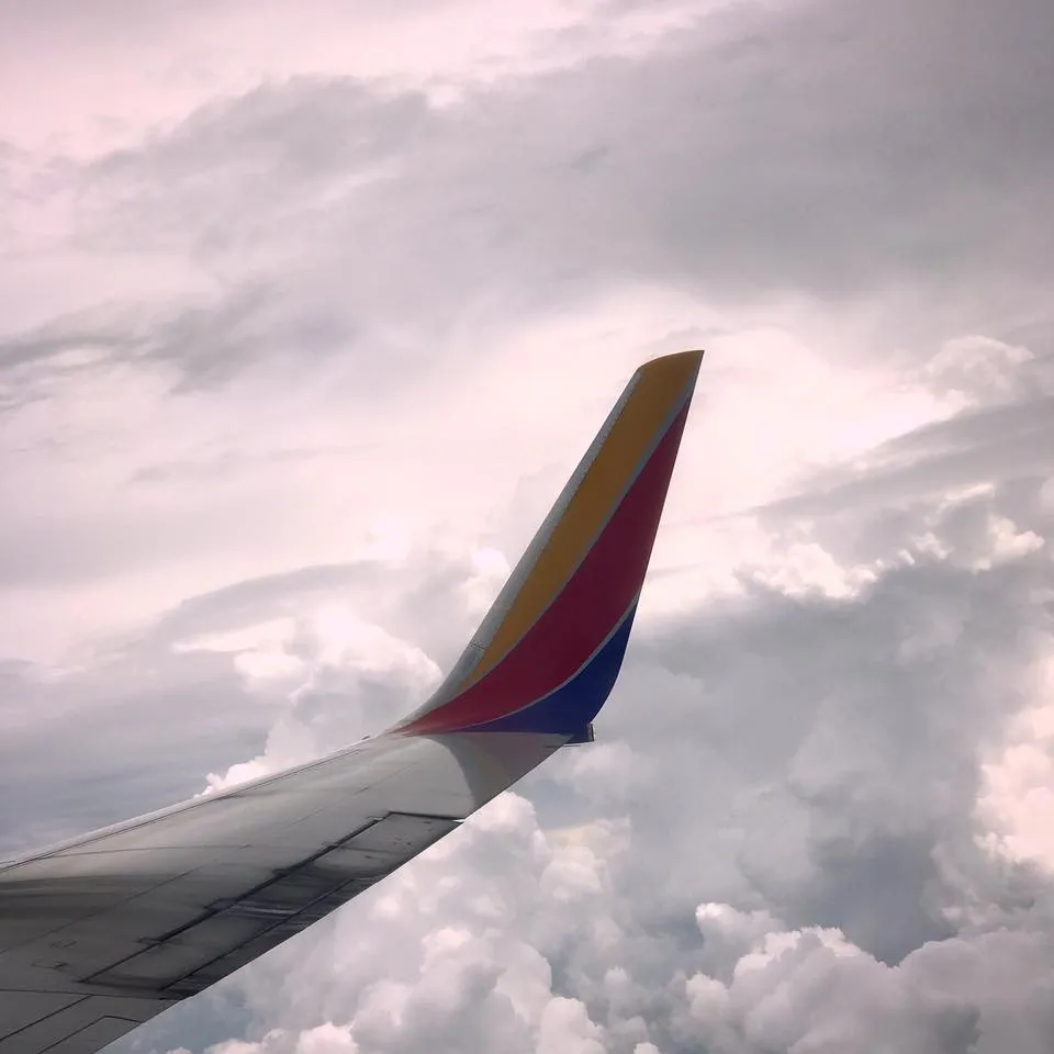 View from a plane window above the clouds