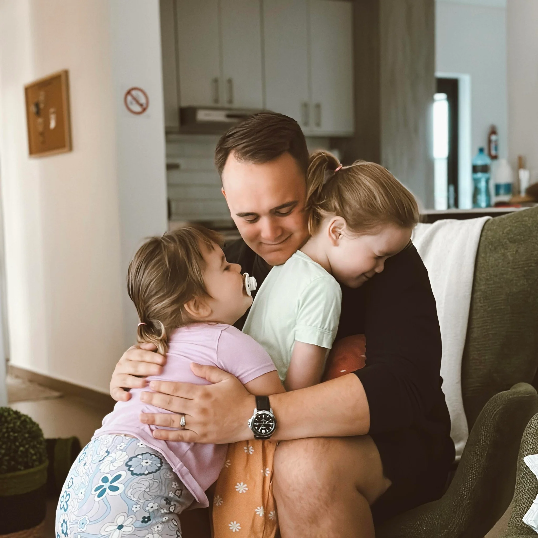 Devin hugging both daughters in South Africa